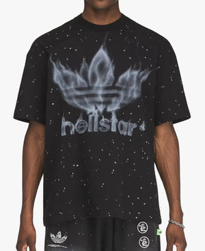 A person wearing a black Adidas x Hellstar short-sleeve t-shirt with a white flame trefoil logo and 'hellstar' text on the front, paired with black shorts featuring white logos.