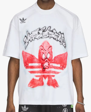 A white short-sleeve t-shirt featuring a red cartoon bird graphic styled like the Adidas logo, with a black graffiti-style outline and a small black Adidas logo on the left chest, worn by a model.